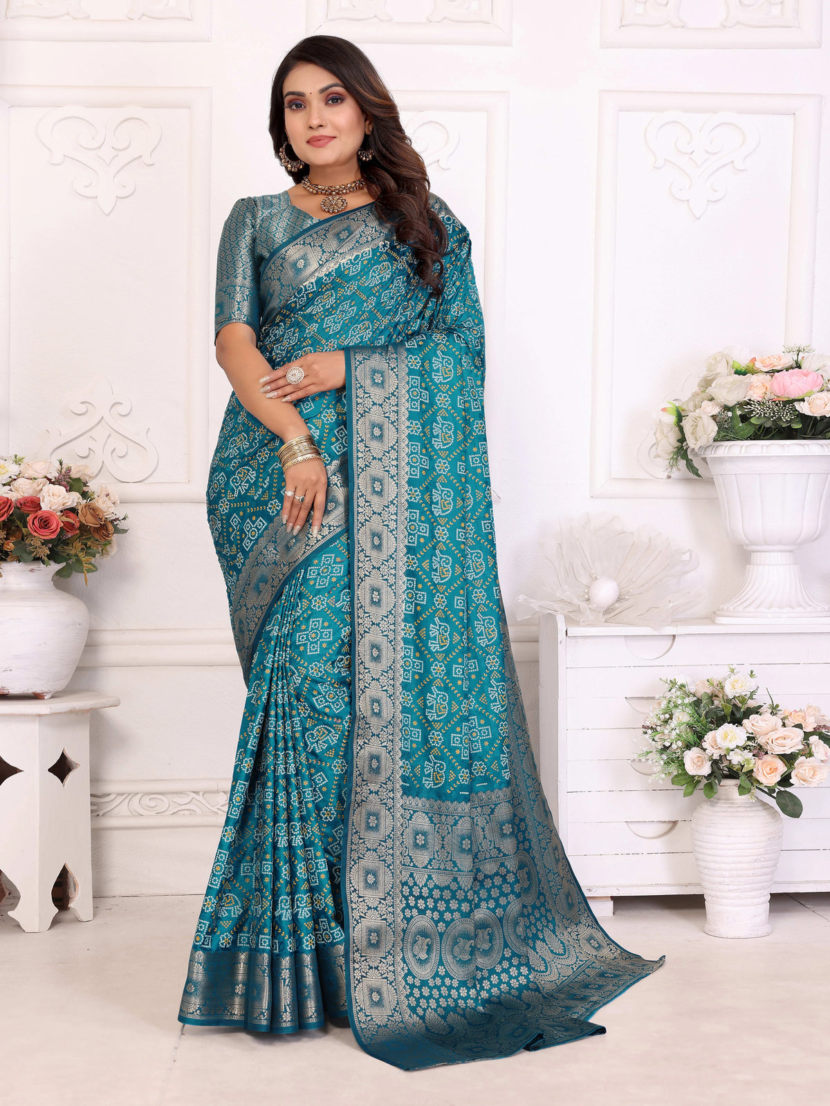 Woman wearing a teal saree with a white background