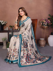 Woman in a saree with floral and peacock patterns in a decorated room.