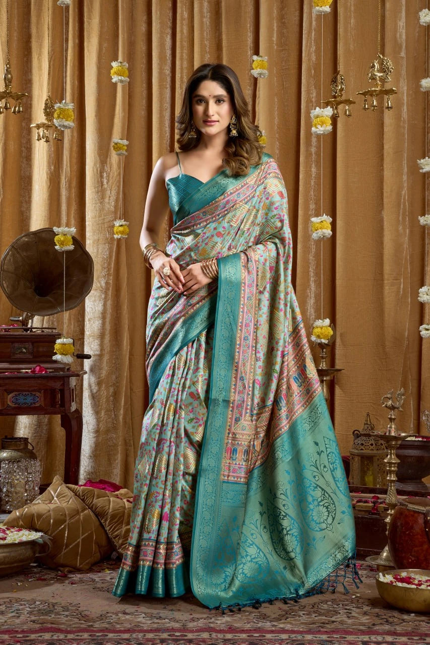 Woman in a traditional saree standing in a decorated room with ornate decor.