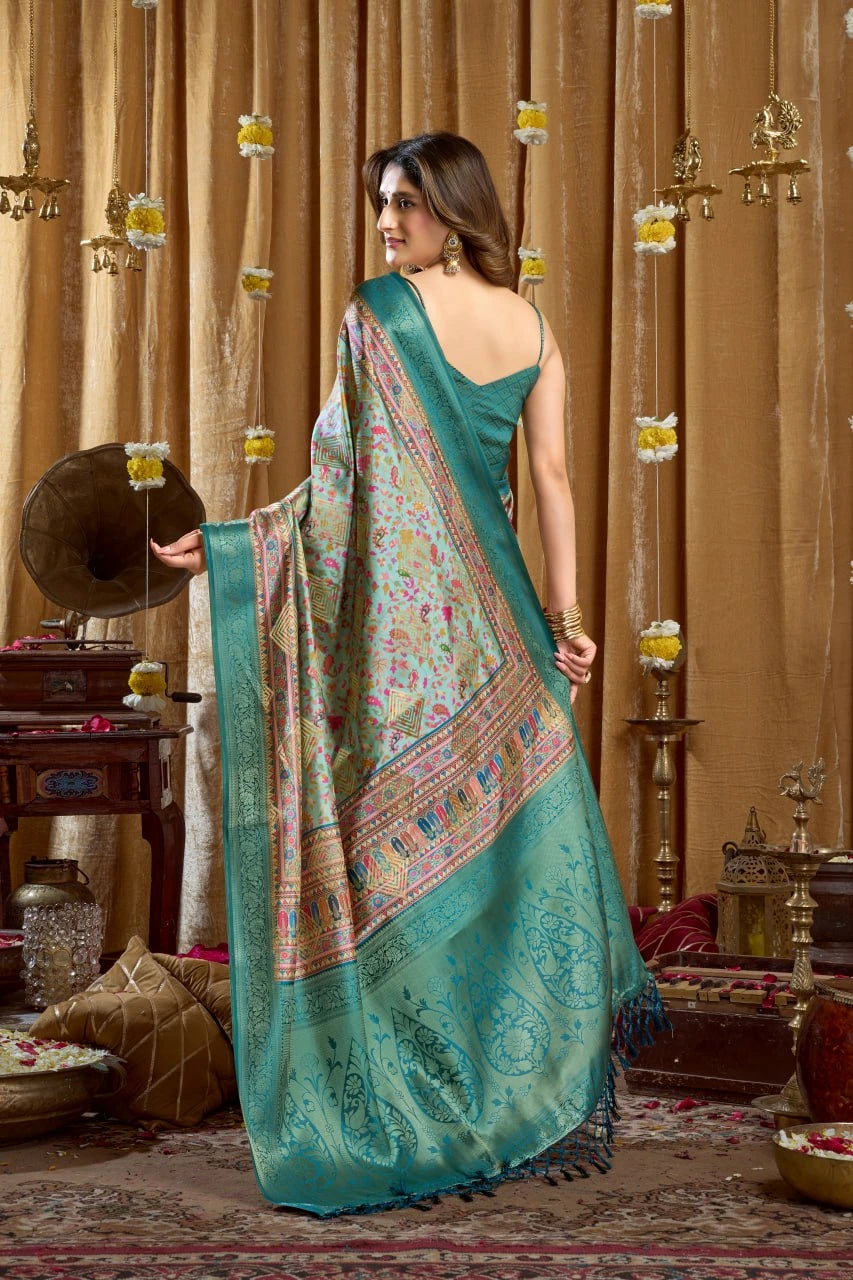 Woman in a teal saree with a decorative backdrop