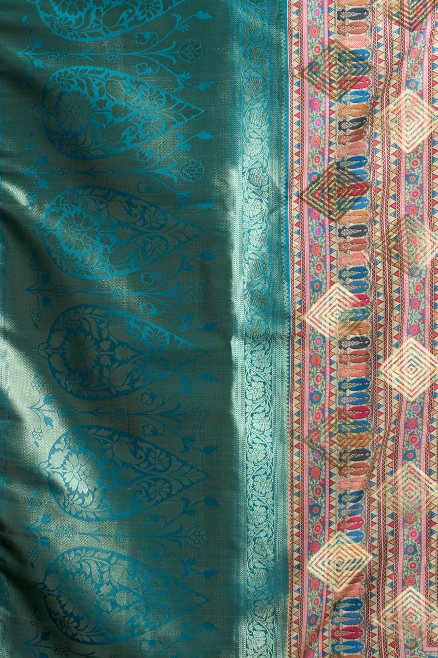 Teal fabric with intricate patterns and a colorful border