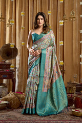 Woman in a traditional saree standing in a decorated room with ornate decor.