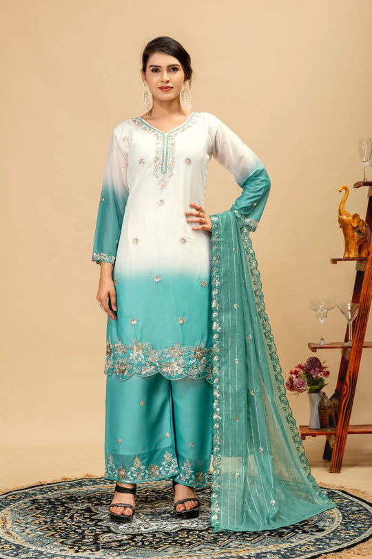 Woman wearing a white and blue embroidered outfit with a beige background
