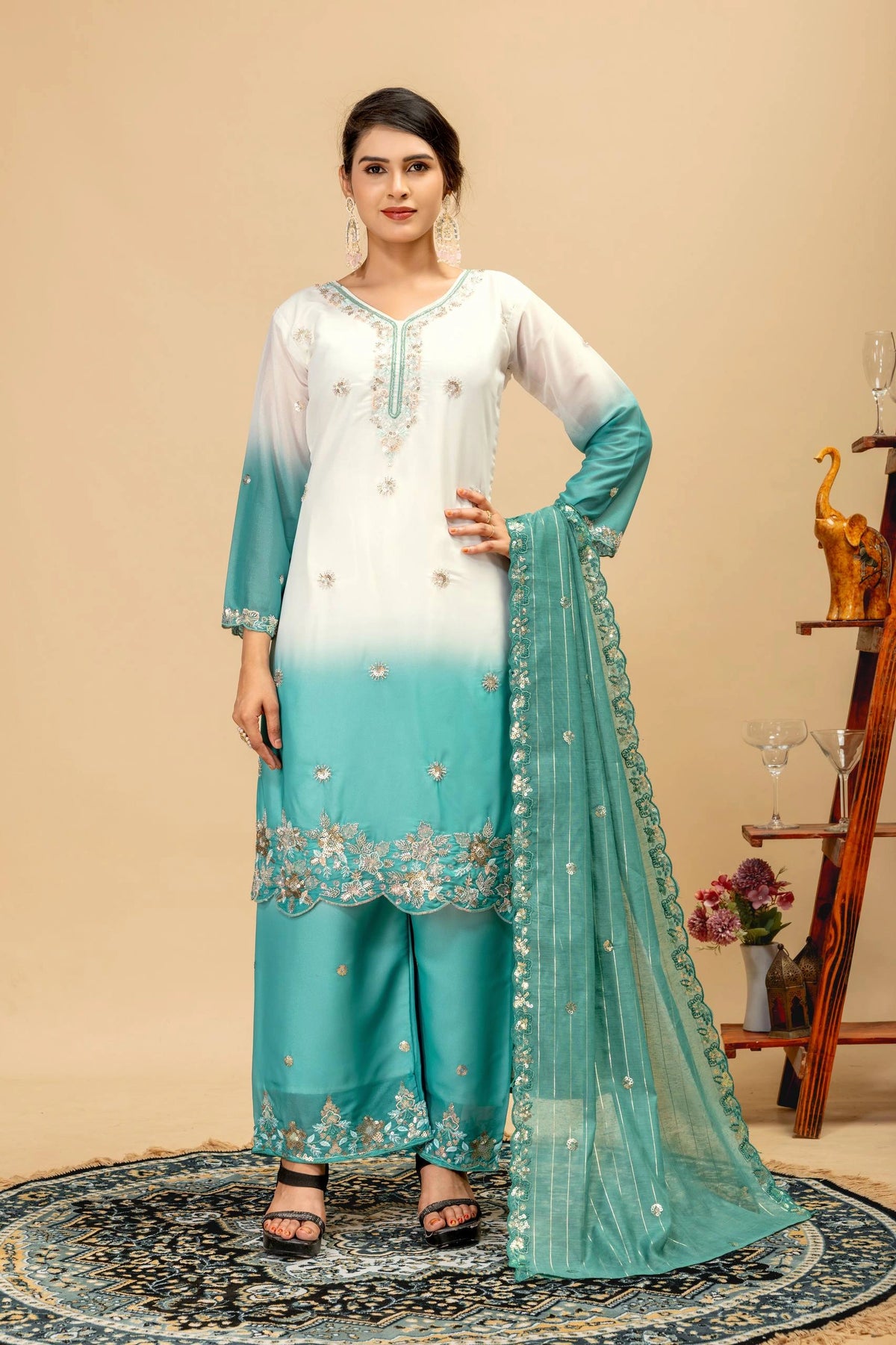 Woman wearing a white and blue embroidered outfit with a beige background