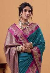 Woman wearing a traditional saree with intricate patterns on a beige background