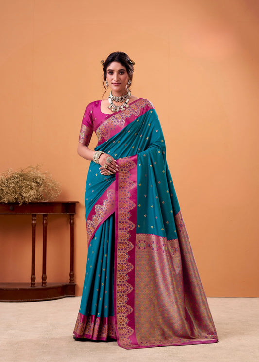 Woman wearing a blue and pink saree with a matching blouse against an orange background