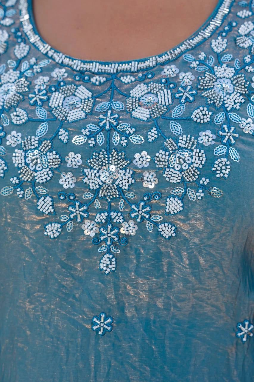 Blue embroidered garment with intricate patterns