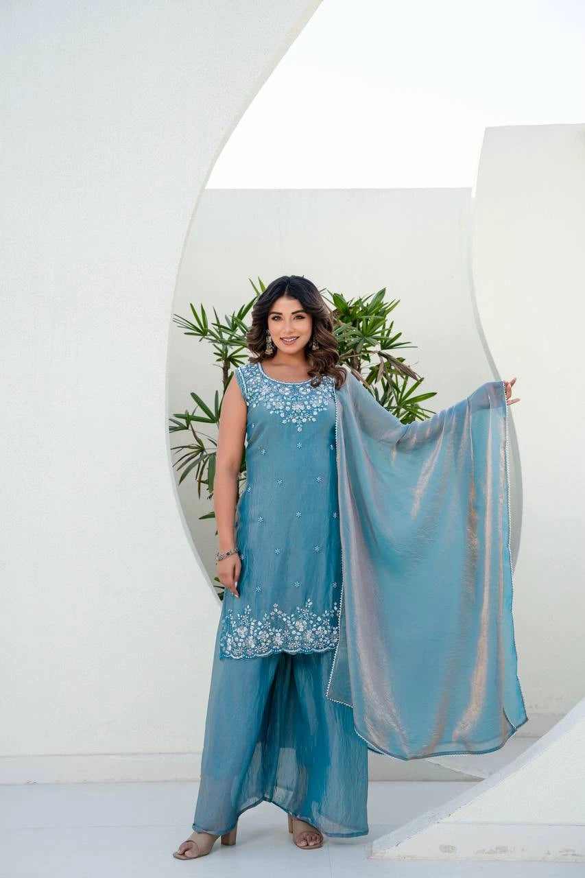 Woman in a blue traditional outfit with a white background