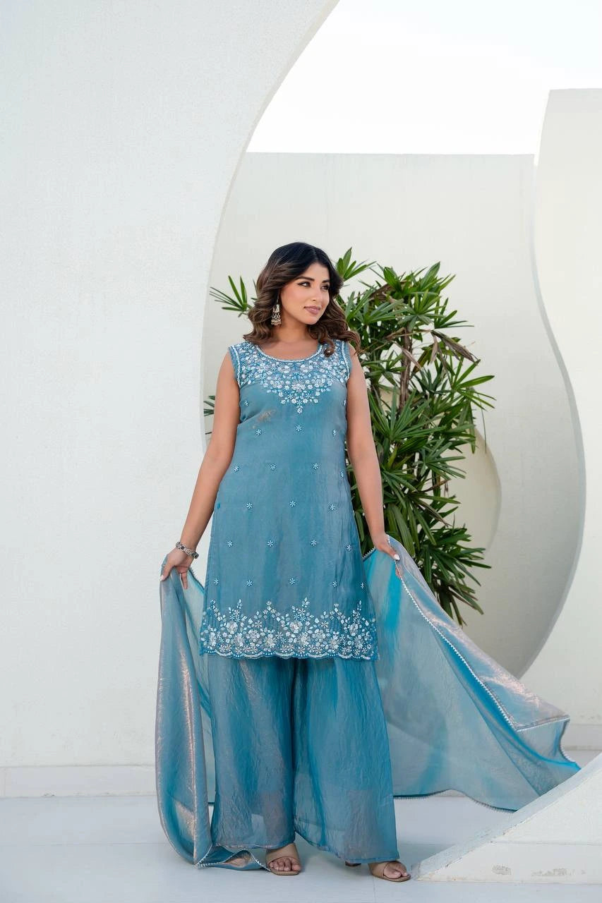 Woman wearing a blue traditional outfit with a white background