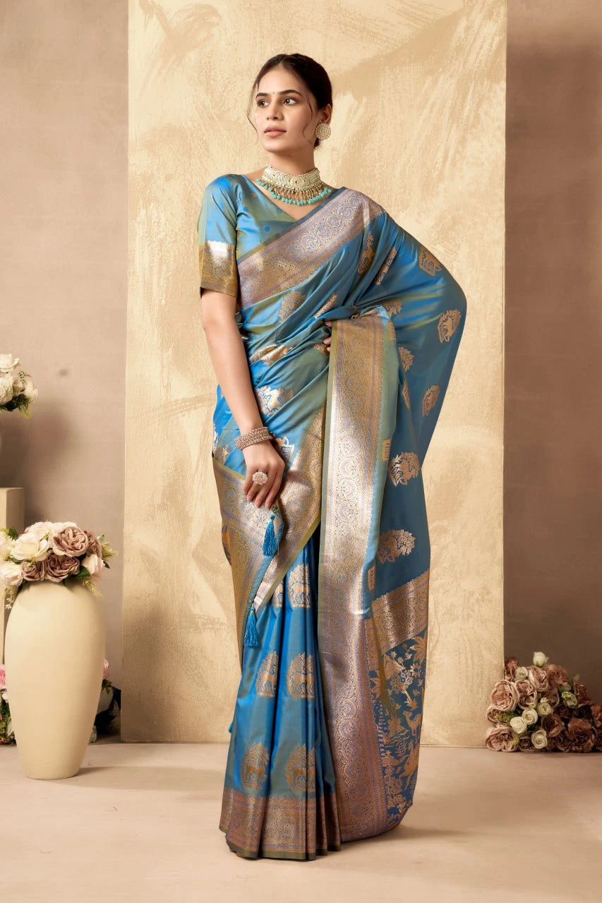 Woman wearing a blue and silver saree with a neutral background