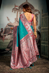 Woman wearing a traditional saree in a decorative setting