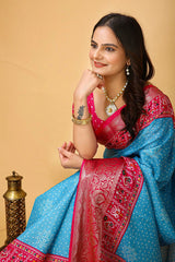 Woman wearing a traditional blue and pink saree with a beige background