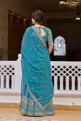 Woman wearing a blue saree with a white background