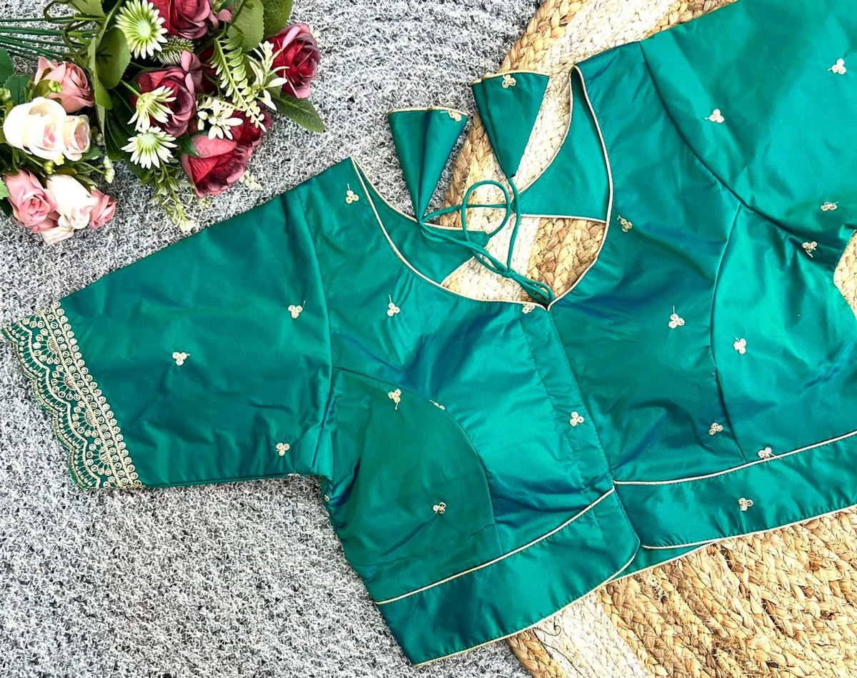 Green traditional outfit with floral decorations on a textured surface