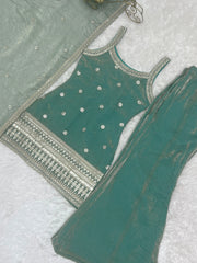 Green embroidered blouse with silver detailing on a white background