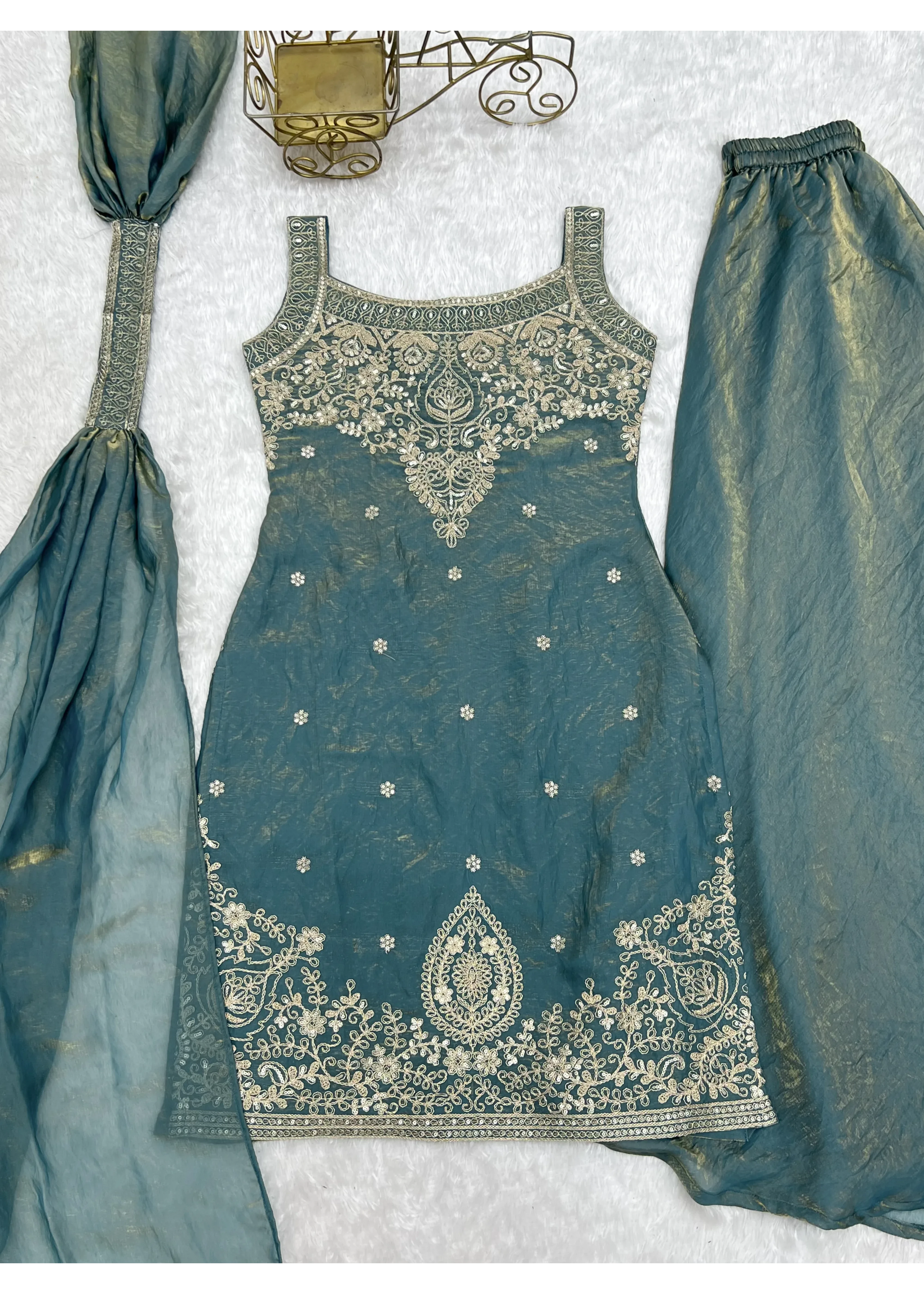 Teal embroidered outfit with matching dupatta on a light gray background