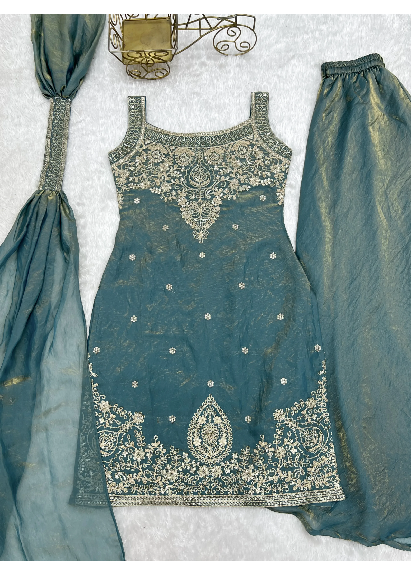 Teal embroidered outfit with matching dupatta on a light gray background