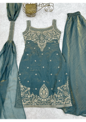 Teal embroidered outfit with matching dupatta on a light gray background