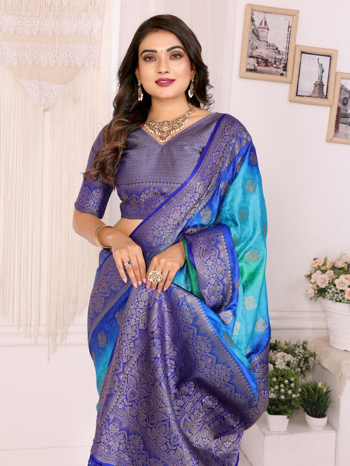 Woman wearing a blue and purple saree with a white background