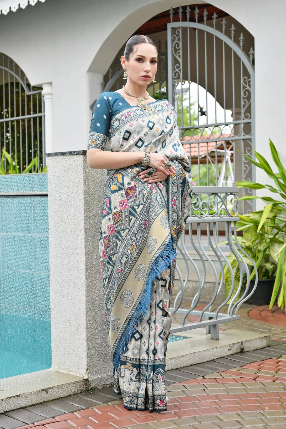 Rama blue Banarasi silk saree with golden zari weaving displayed on mannequin.