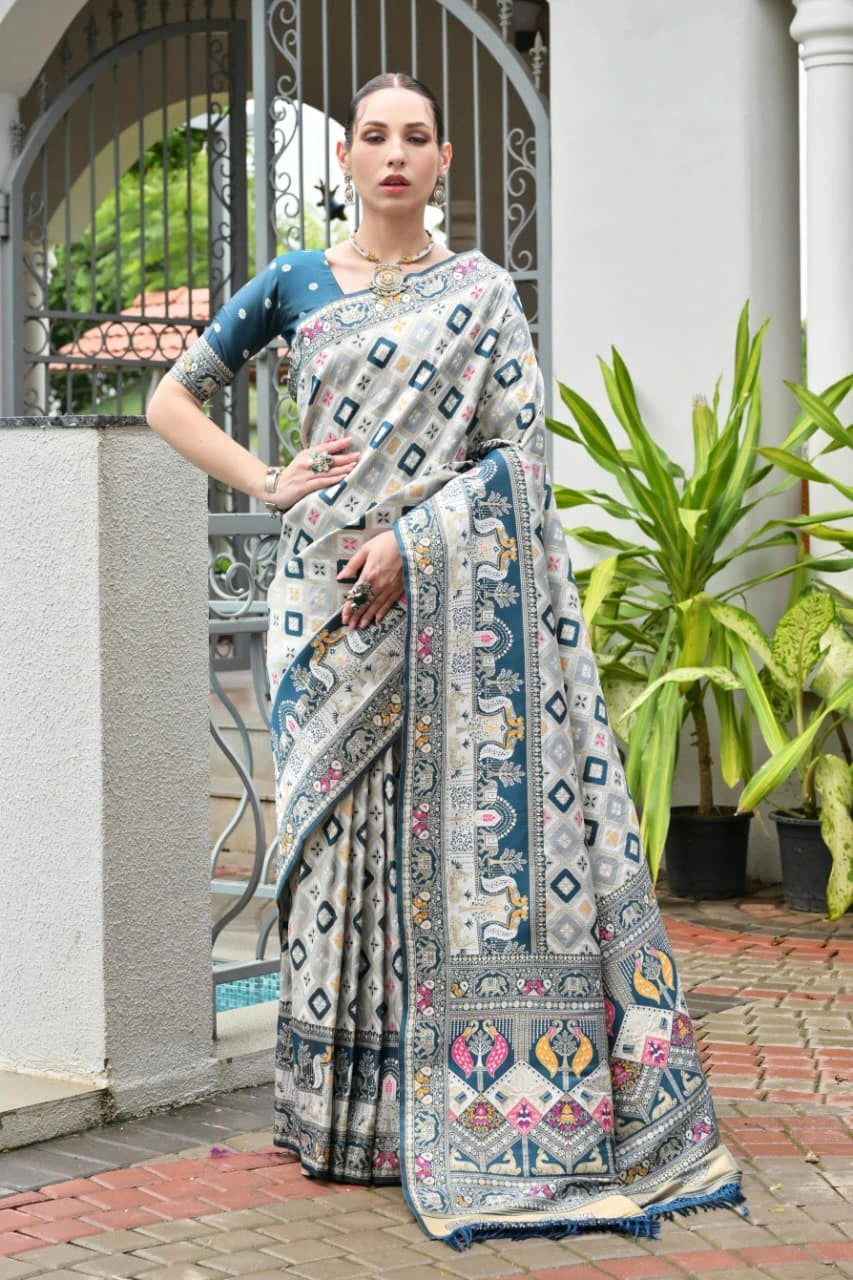Rama blue Banarasi silk saree with intricate golden zari weaving displayed on mannequin.