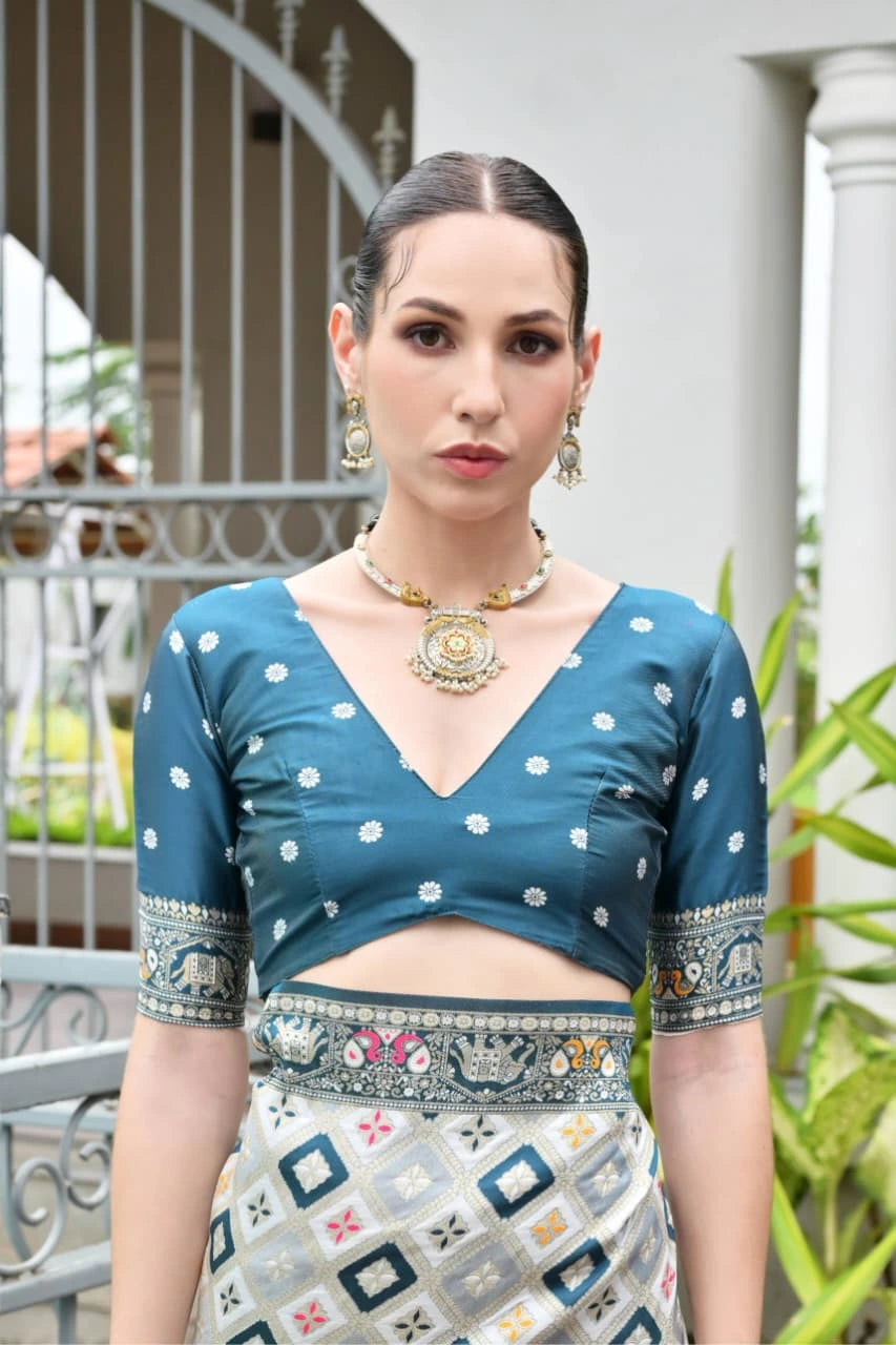 Luxurious Rama blue soft silk saree folded neatly, showcasing fine zari weaving details