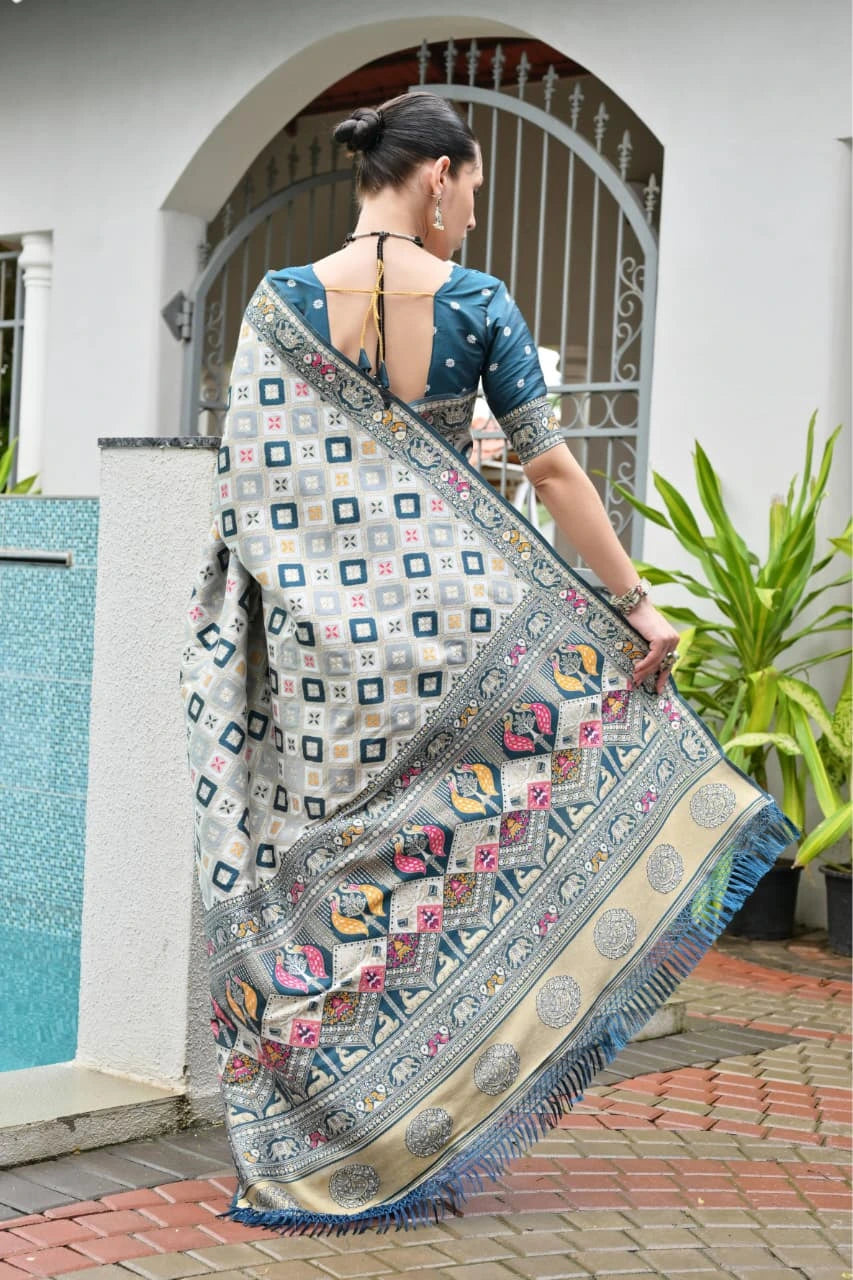 Traditional Banarasi silk saree in Rama blue with ornate zari patterns draped gracefully.