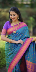 Woman wearing a blue saree with pink and purple border outdoors