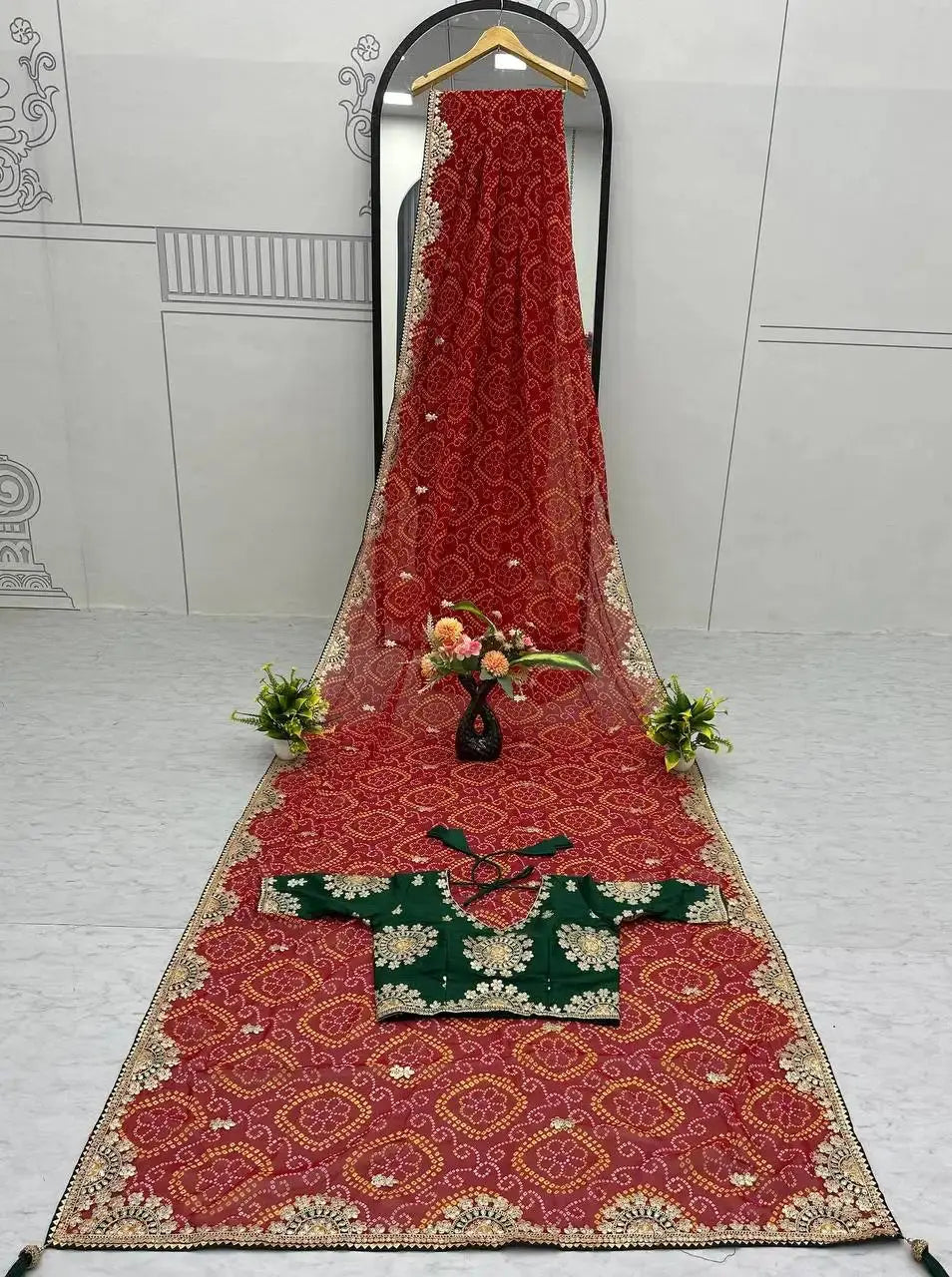Flat lay of Red Gota Patti Saree with bandhani print and zari border