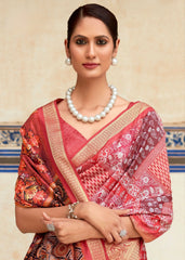 Woman wearing a red saree with floral patterns and a pearl necklace against a decorative wall.