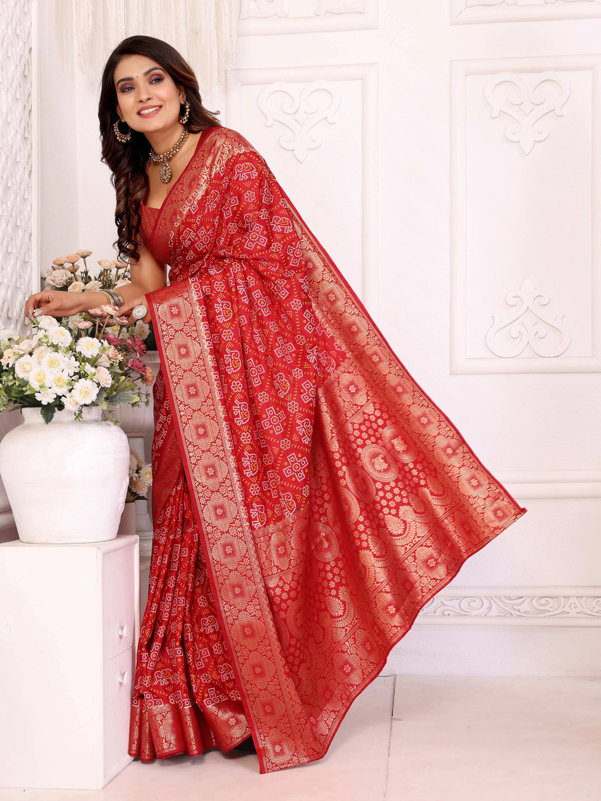 Woman wearing a red saree with a white background