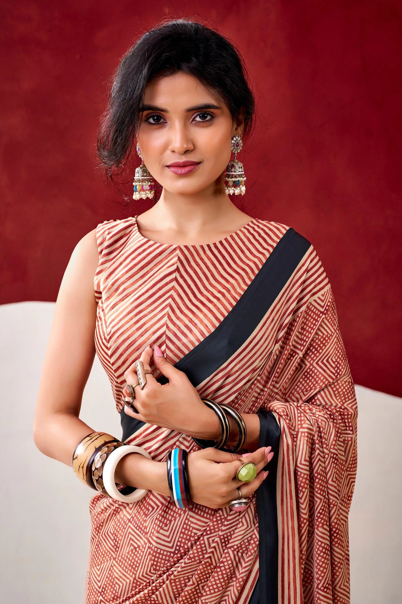Woman wearing a traditional saree with a red background