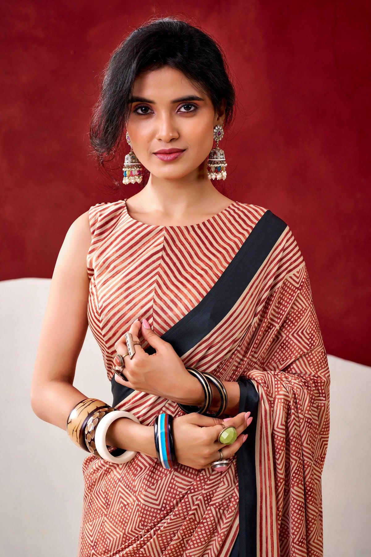 Woman wearing a traditional saree with a red background