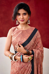 Woman wearing a traditional saree with a red background