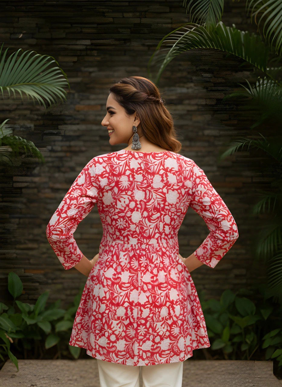 Red cotton short kurti with vibrant digital floral print, round neckline, and 3/4th sleeves — stylish casual wear for everyday comfort