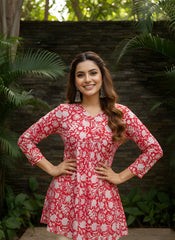 Red cotton short kurti with vibrant digital floral print, round neckline, and 3/4th sleeves — stylish casual wear for everyday comfort