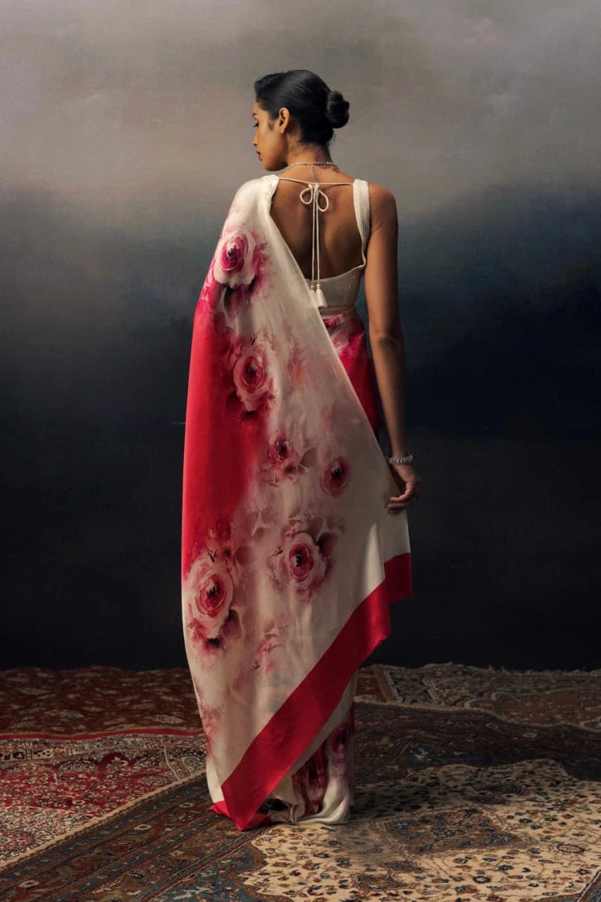 Woman wearing a floral saree with a dark background