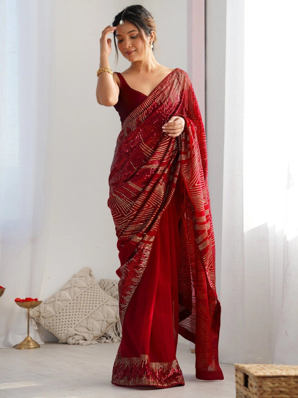 Woman wearing a red saree with a white background
