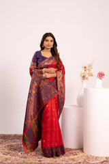 Woman wearing a red and blue saree with a white background