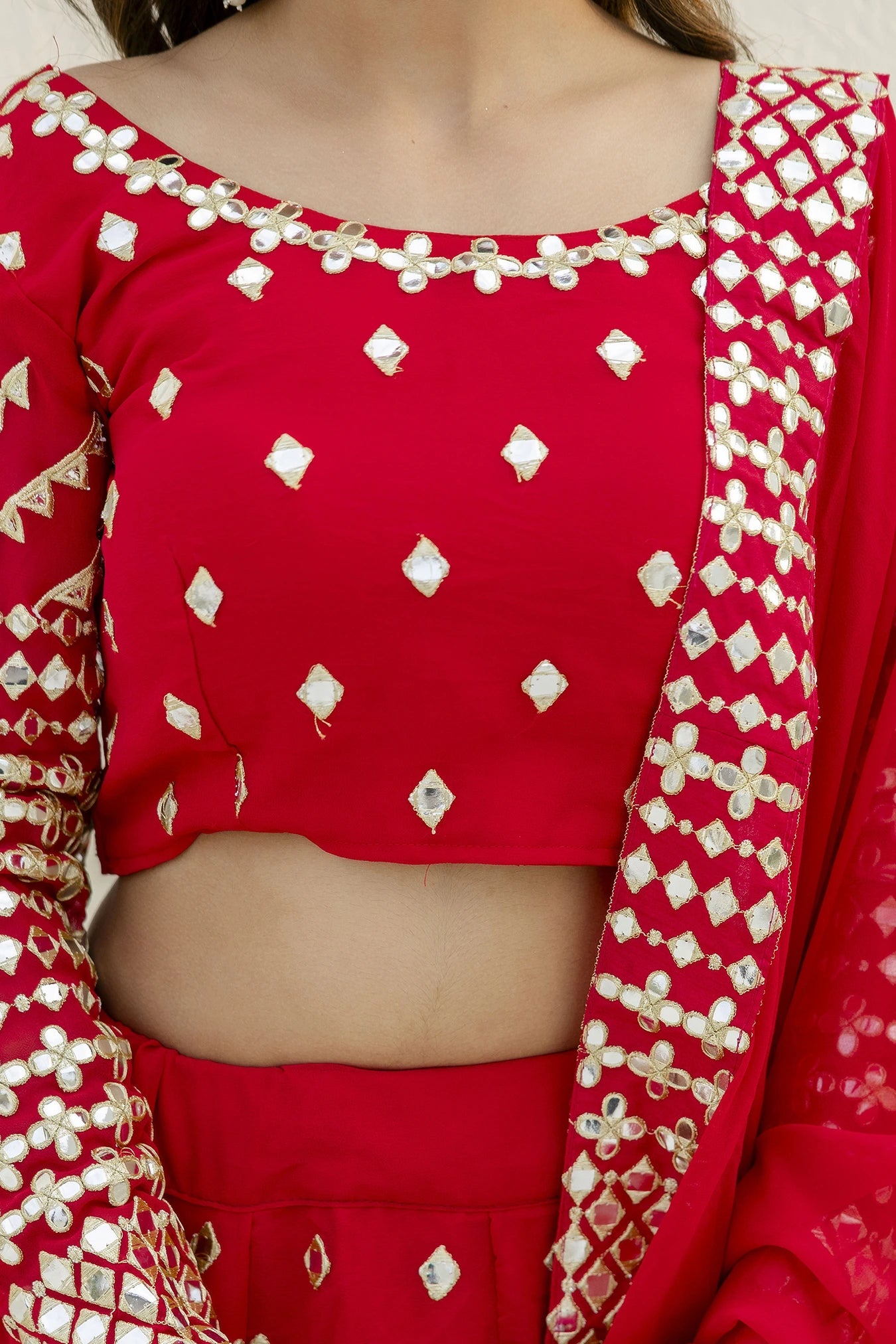 Red traditional outfit with white patterns on a plain background