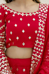 Red traditional outfit with white patterns on a plain background