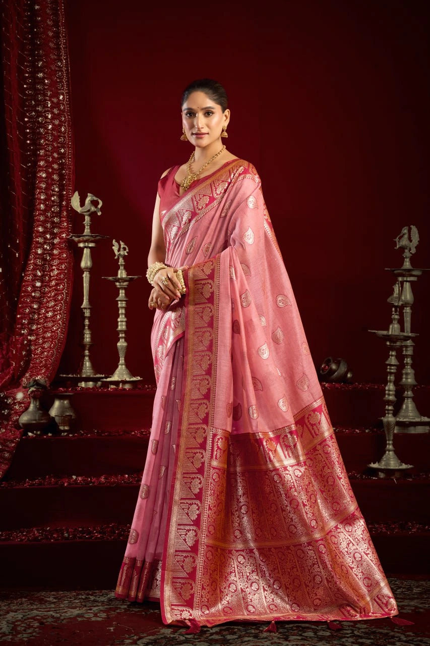 Woman in a pink saree with a red background