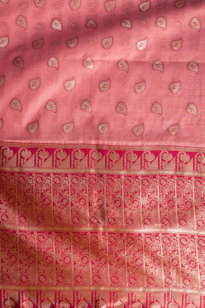 Pink fabric with intricate patterns and a border