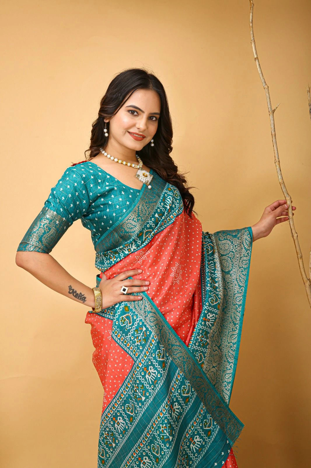 Woman wearing a traditional saree with a gold background