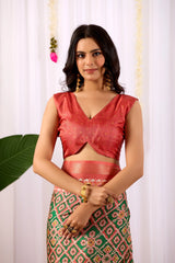 Woman wearing a red blouse and patterned skirt against a white background