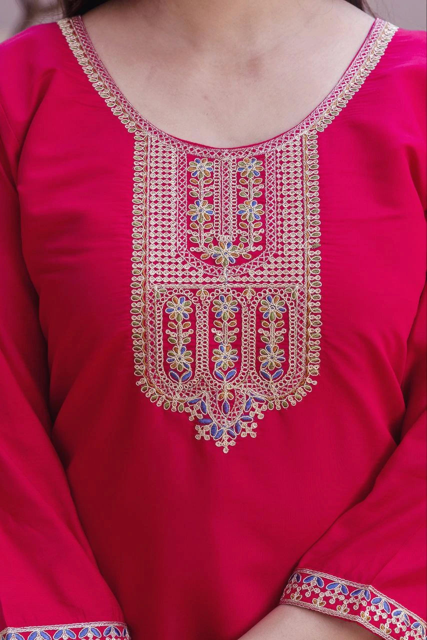 Close-up of a red garment with intricate gold embroidery