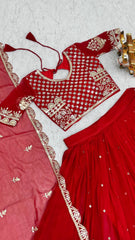 Red traditional outfit with intricate white embroidery on a light gray background