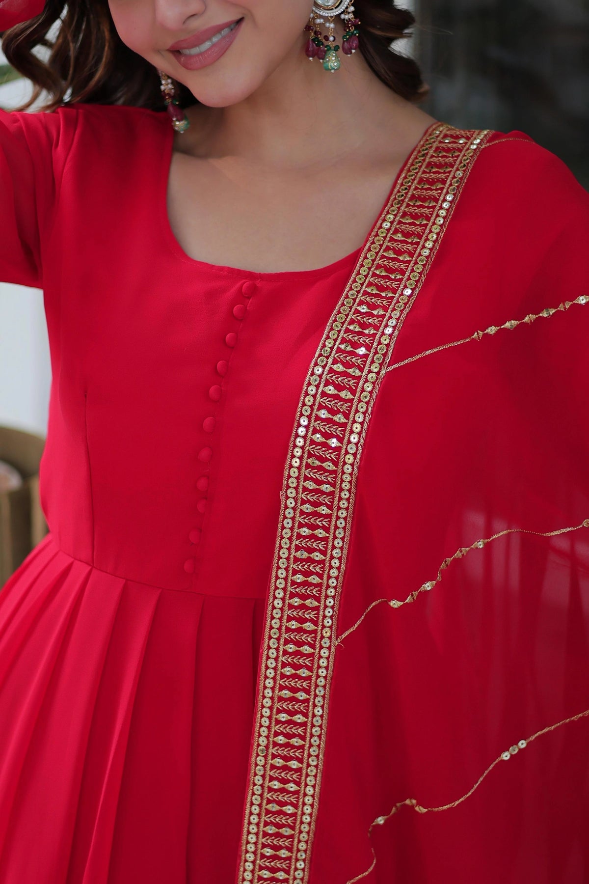 Red dress with gold embroidery on a blurred background