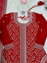 Red embroidered garment with white patterns on a light background