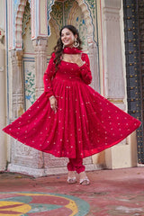Woman in a red traditional outfit standing in front of an ornate architectural background